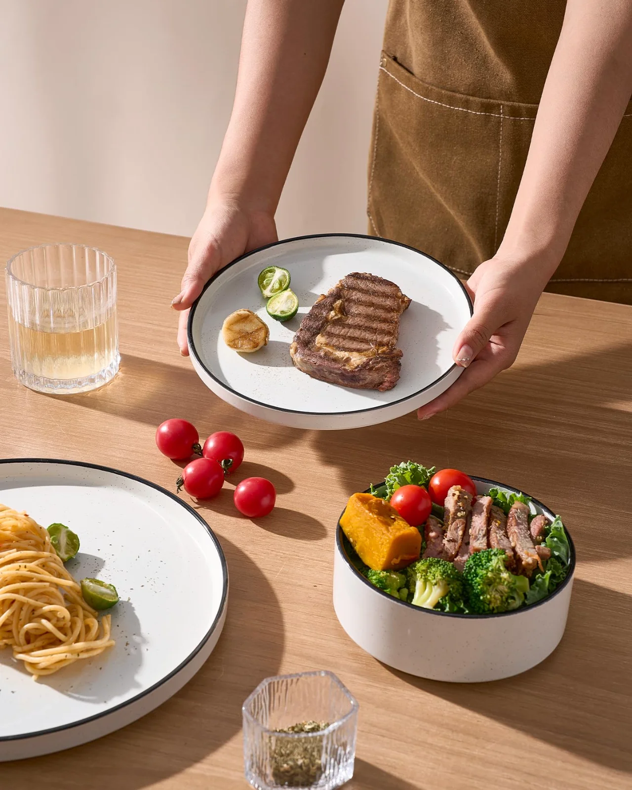 A dinner plate set down beside a bowl of vegetables