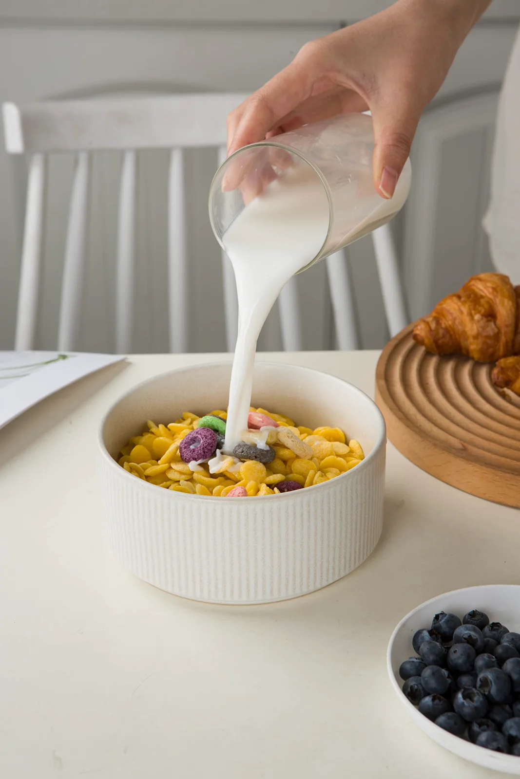 Milk going into a cereal bowl, 5.5 inches across