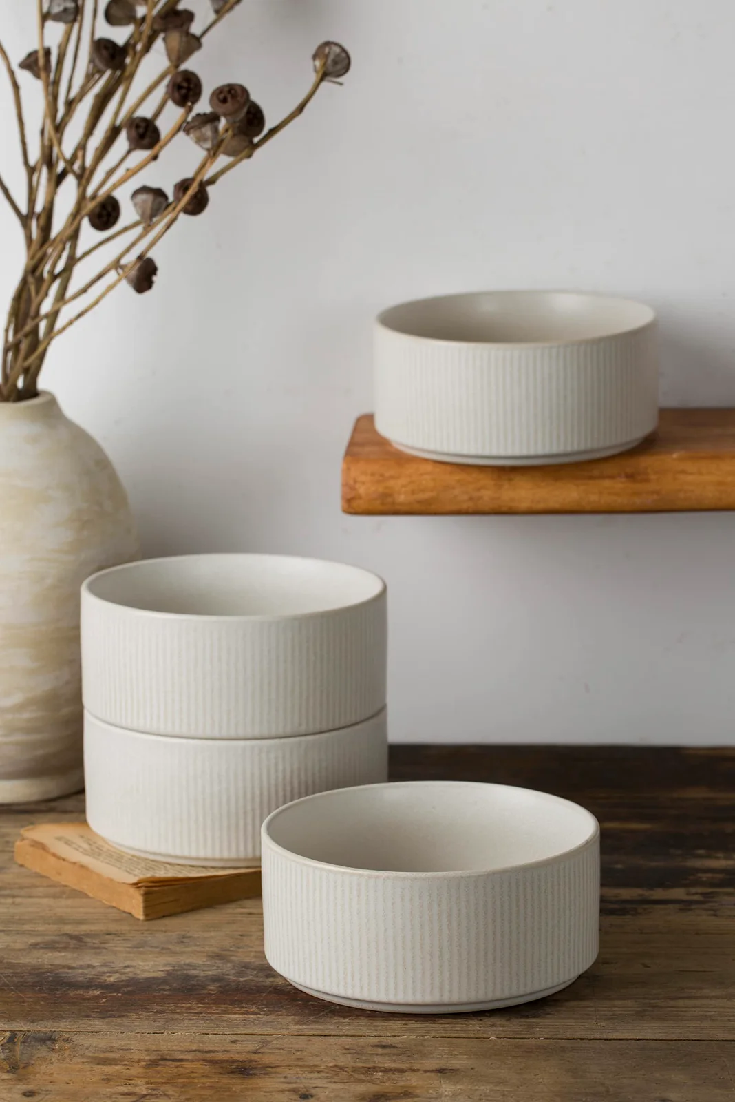 Cereal bowls on a shelf, glaze pooling at the rims