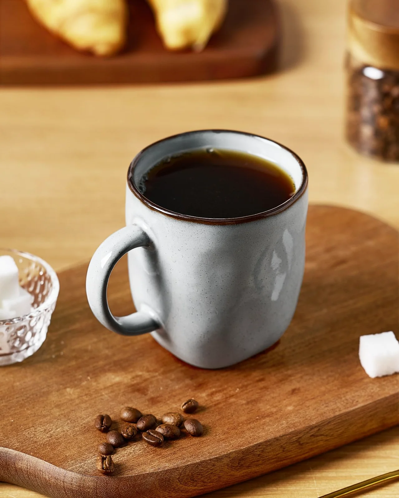 Black coffee in a 13 oz mug, on a board