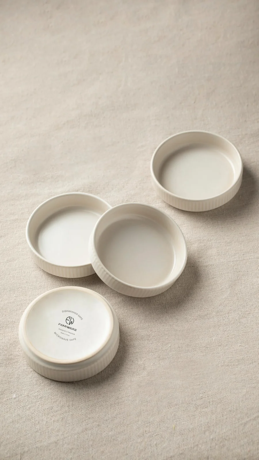 Three dipping dishes on linen, the glaze pooling at each rim
